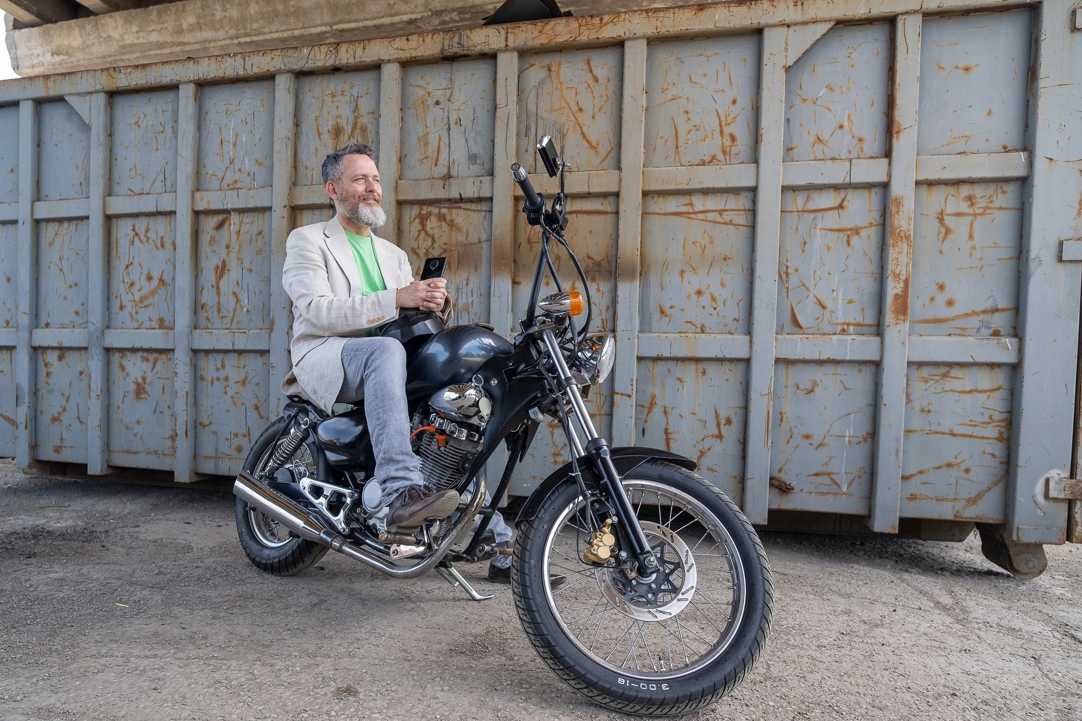 Motorcyclist riding a bobber motorcycle on the road