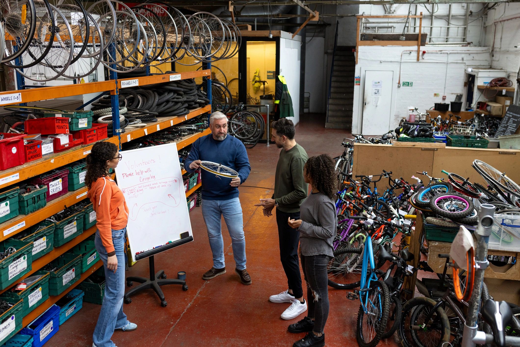 Team collaborating around motorcycle gear and accessories