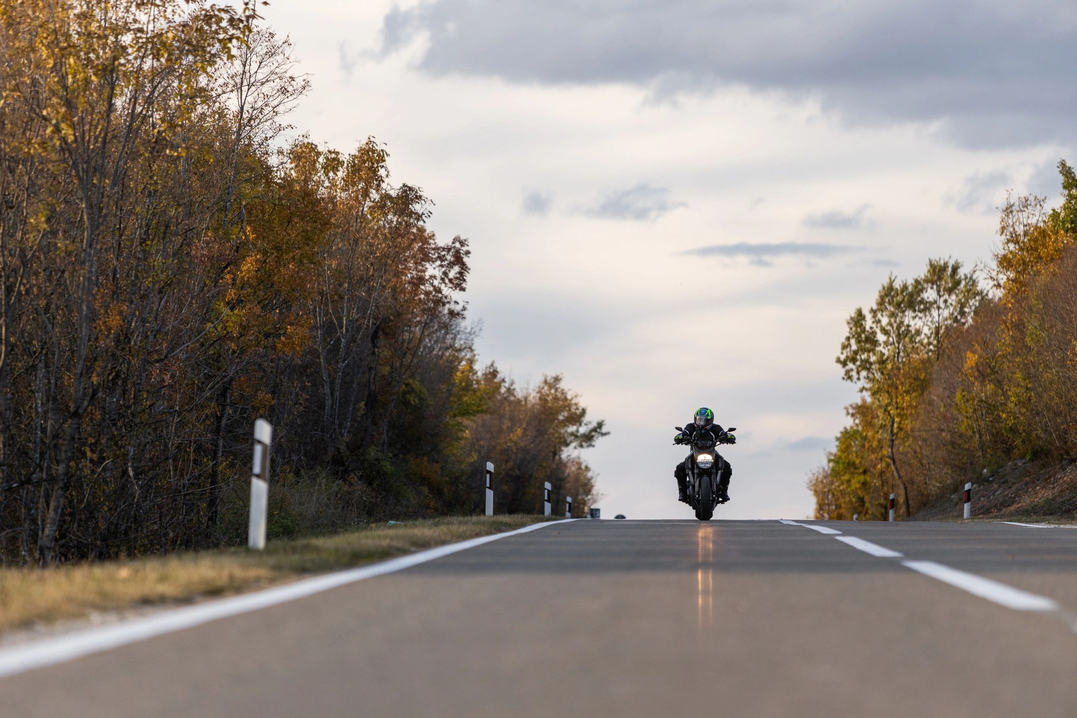 Motorcycle rider on an open road at sunset